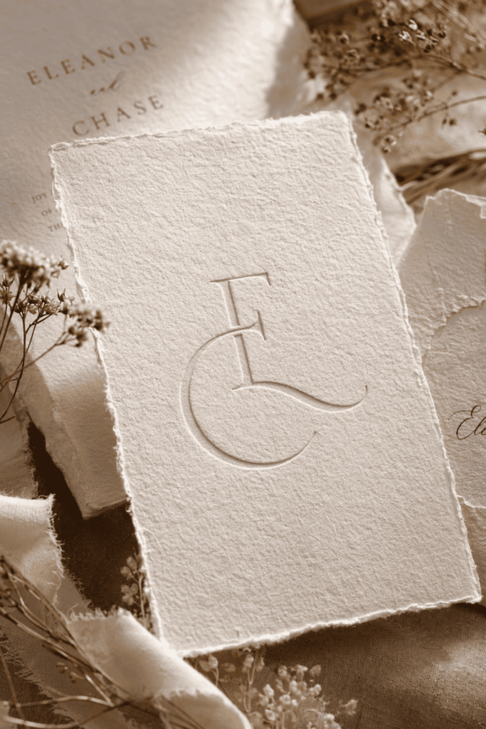 Minimalist signature wedding monogram embossed on handmade paper