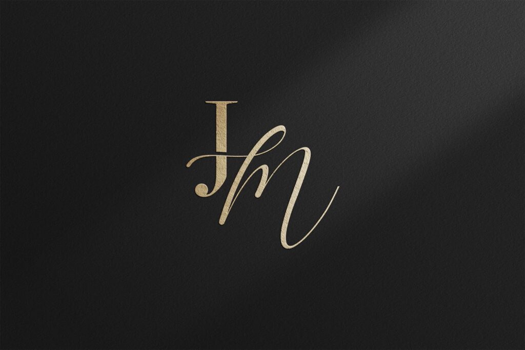 Elegant old money wedding logo in gold on black textured paper