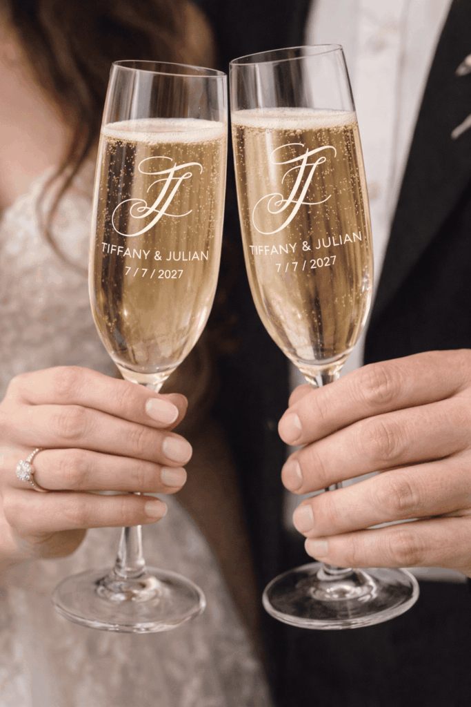 Calligraphy wedding monogram engraved on champagne glasses